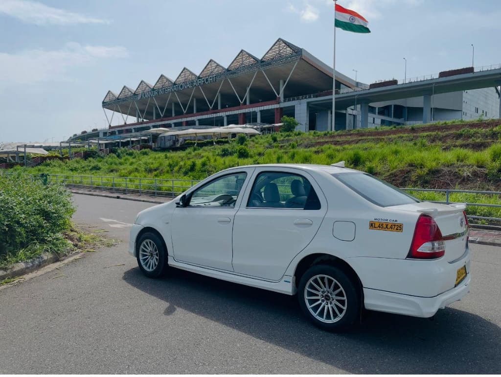 MR.TAXI white Toyota Etios sedan at Kannur International Airport